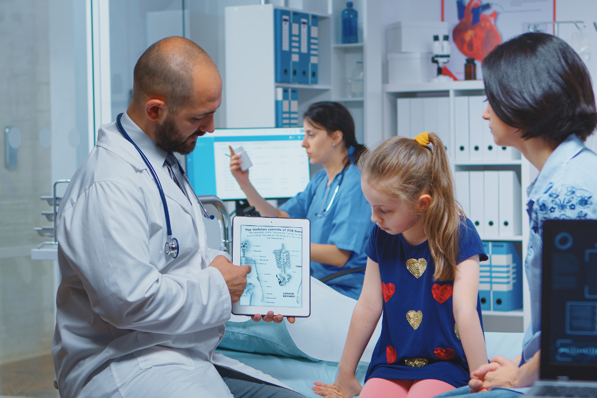 Pediatric oncology specialists reviewing child lung imaging results